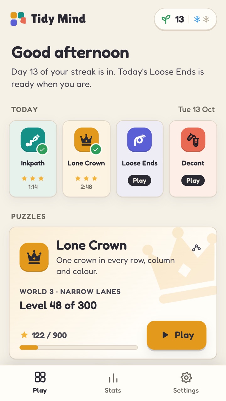 The Home screen: a 13-day streak, today’s four daily puzzles with two already solved, and the Lone Crown card