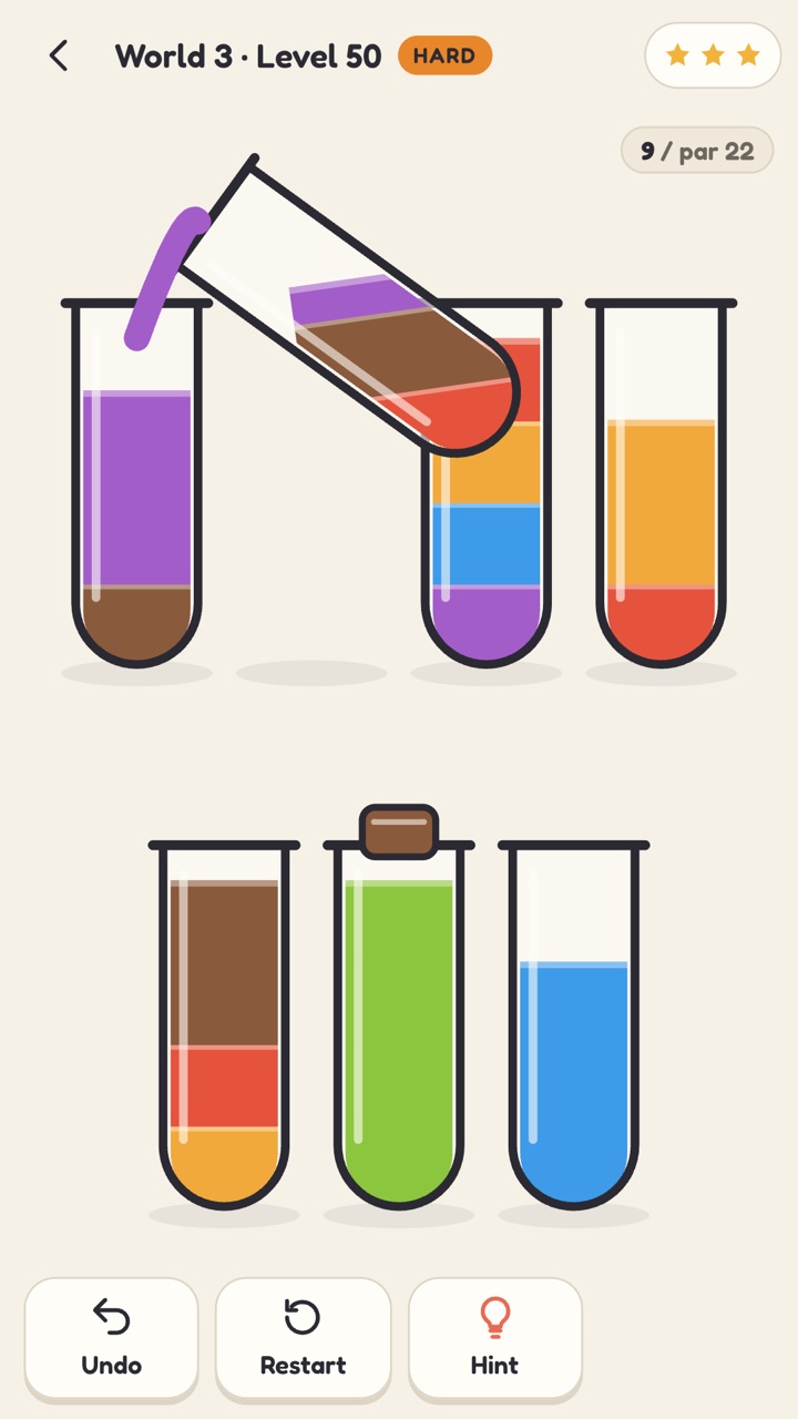 Decant mid-pour: a flask tipping a ribbon of colour into another on a shelf of seven flasks